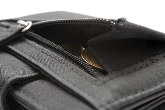 Black wallet opened with coins inside on white background