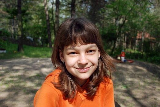 cheerful smiling caucasian girl portrait outdoor on sunlight