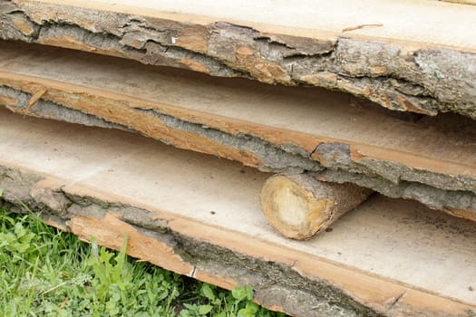 Board lumber lying in stack on the grass