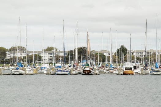 Row of yachts on pier on overcast day