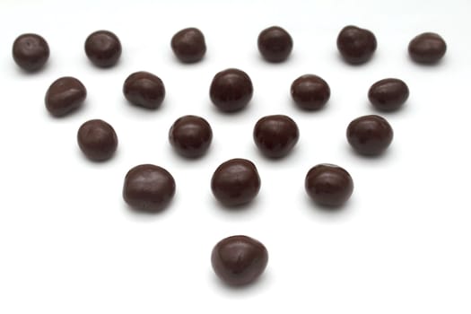 Dark chokolate sweets forming a triangle