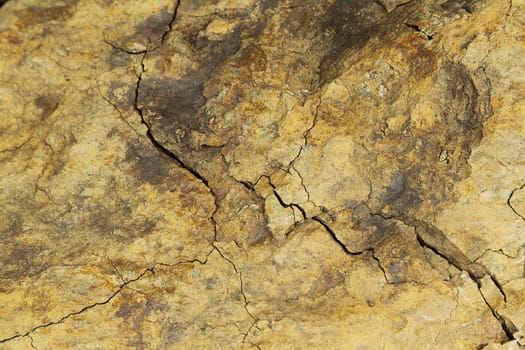 Old brown cracked rock close up photo 
