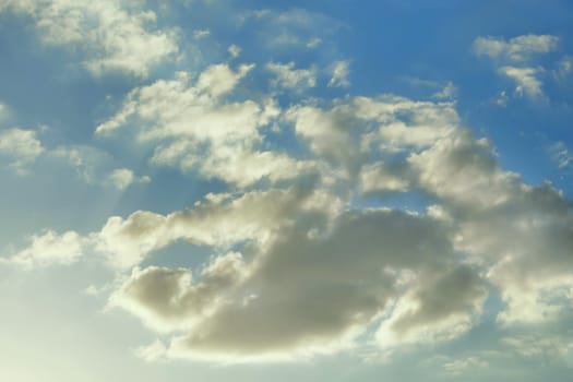 Light gray clouds on the background of a blue sky