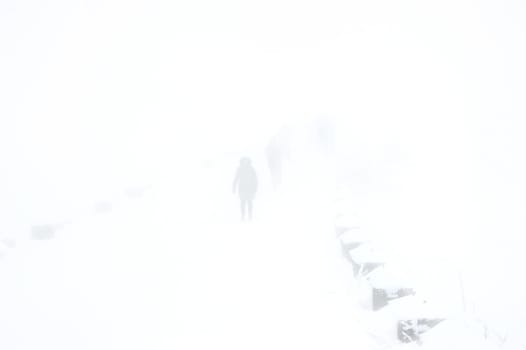 People walking by the road in heavy snowfall