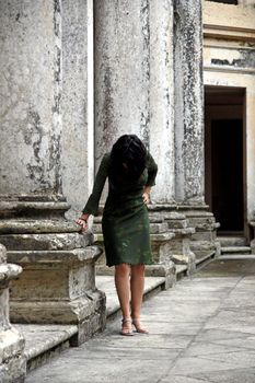 view of a lonely woman inside an old and ancient place.