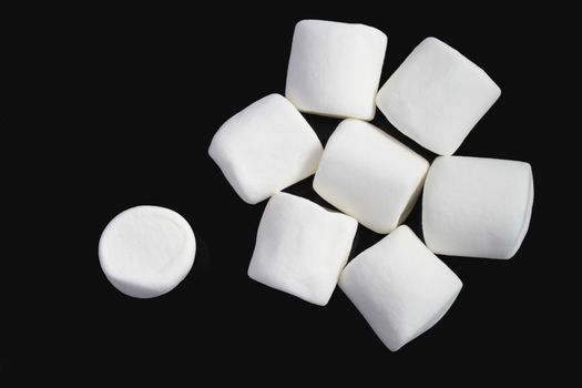 White marshmallows on black background