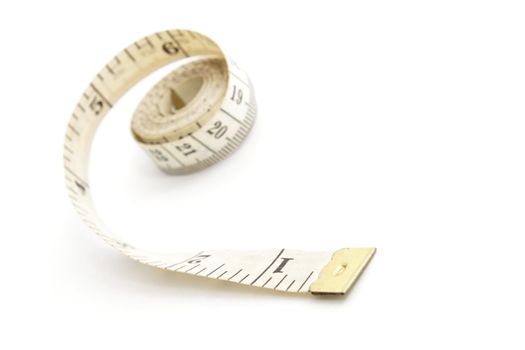 Measuring tape isolated on white background, shallow depth of field