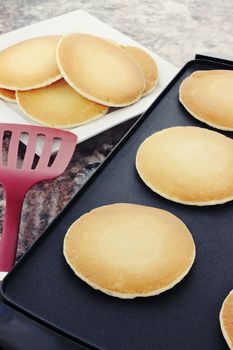 Preparing fresh pancakes on a non-stick griddle.