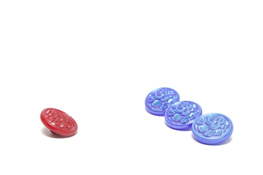 One red button and three blue ones isolated on white background