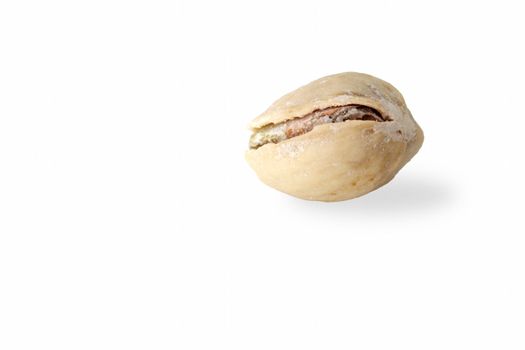 Single salted pistachio on the white background