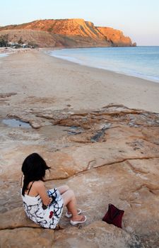 View of a young girl watching the beautiful sea.