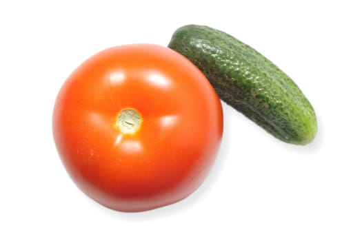 Red ripe tomato and a cucumber isolated on white background