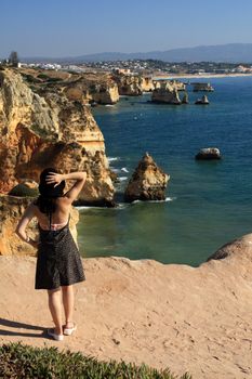 view of a beautiful woman watching the coastline near Lagos.