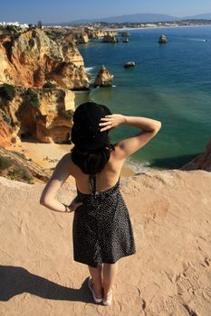 view of a beautiful woman watching the coastline near Lagos.