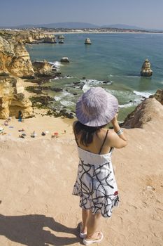 view of a beautiful woman watching the coastline near Lagos.