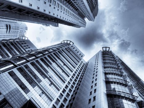 Corporate building soaring against dramatic sky selenium tonedS