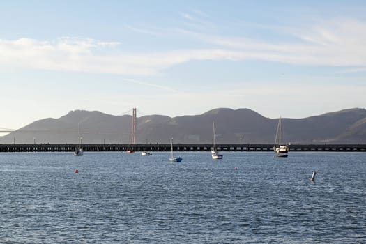 A seascape with boats and view on Golden Gate Bridge