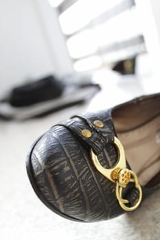 Closeup of women shoe on the floor, open door as background