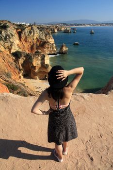 view of a beautiful woman watching the coastline near Lagos.