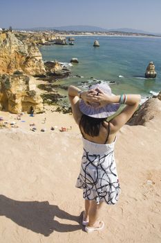 view of a beautiful woman watching the coastline near Lagos.