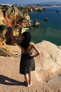 view of a beautiful woman watching the coastline near Lagos.