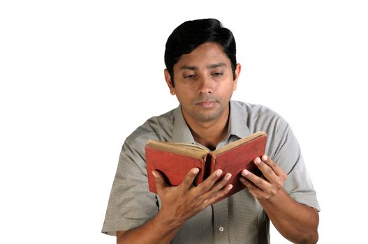 An handsome middle aged man reading an old book