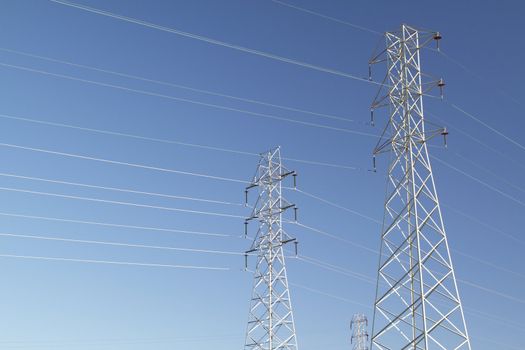 High voltage power lines over blue sky