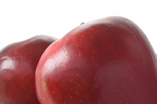 Two red ripe apples on white background