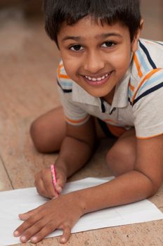 an handsome indian kid doing homework