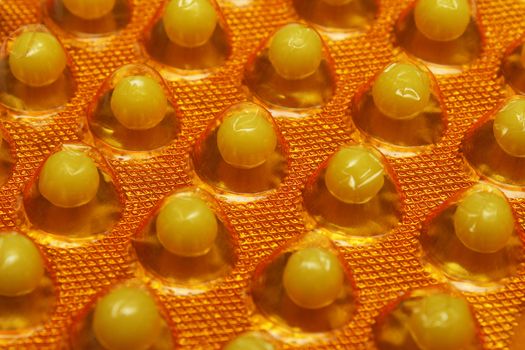 Closeup photo of round vitamin C pills in the pack