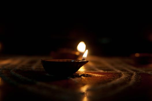 A mud lamp lit on the auspicious occasion of diwali