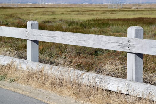 Old wooden fence with field of glass as background