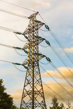 Electricity pylon with clouds and trees in the backround