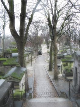alley of parisian cemetery Pere Lachaise in the morning