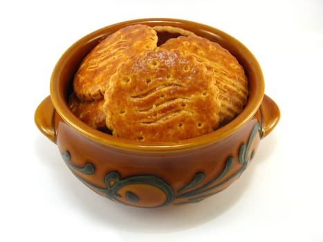 image of a bowl full of biscuits over a white background