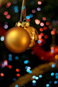 Christmas golden ball with a light blur creating bokeh in the background