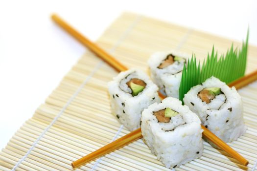 4 rolls of sushi, in a zen attitude