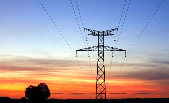 Electricity pylons, over a sunset sky