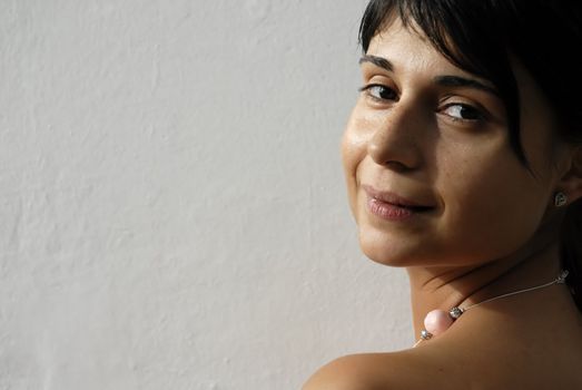 young woman portrait looking sexy in a white wall