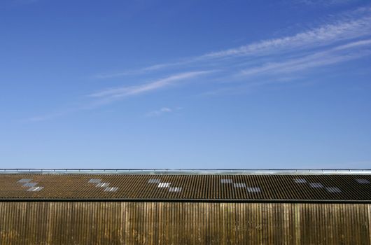 Wooden storehouse in the countryside, with a blue sky background 