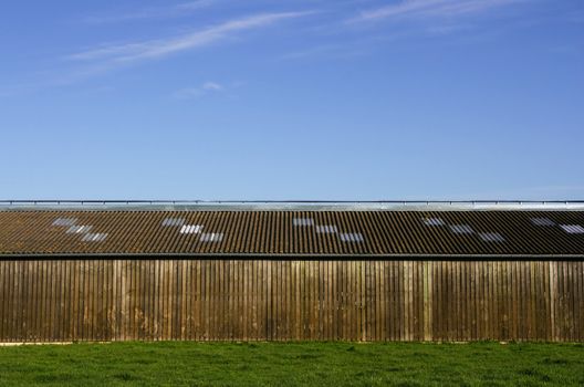 Wooden storehouse in the countryside, with a blue sky background