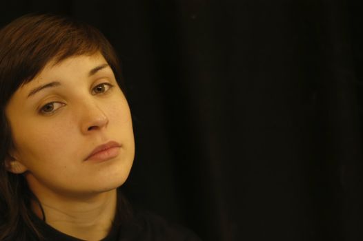 young woman portrait in a black background