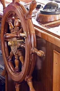 Rudder with compass in background on a yacht