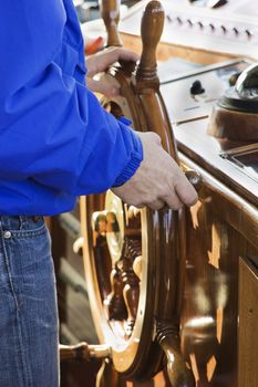 Captain controlling rudder on a yacht