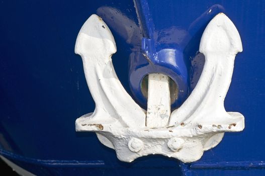 White anchor on the bow of blue boat