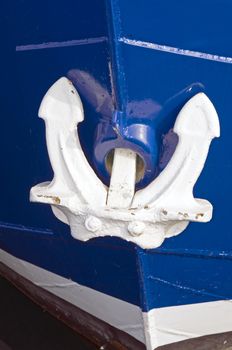 White anchor on the bow of blue boat