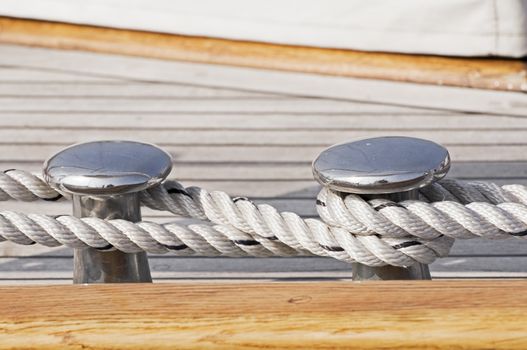 Close-up of rope securing a wooden boat to dock