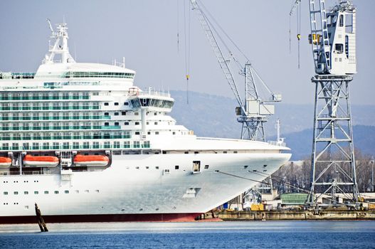 Ship under construction in a dockyard with cranes