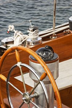 Rudder and compass on a wooden boat