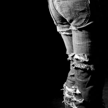 Lacerated jeans, ragged  pants, girl,  black background